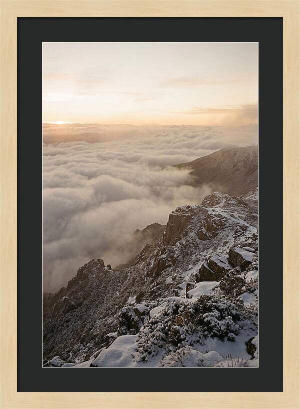 Snow Covered Ridge Line Above Sea Of Clouds