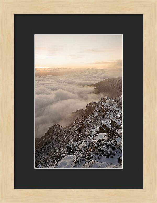 Snow Covered Ridge Line Above Sea Of Clouds