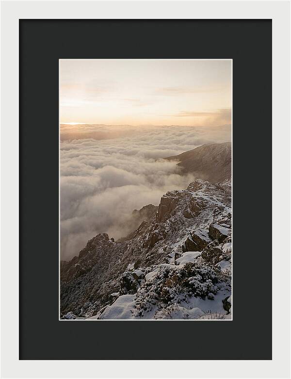 Snow Covered Ridge Line Above Sea Of Clouds
