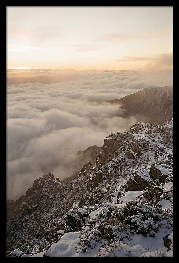 Snow Covered Ridge Line Above Sea Of Clouds