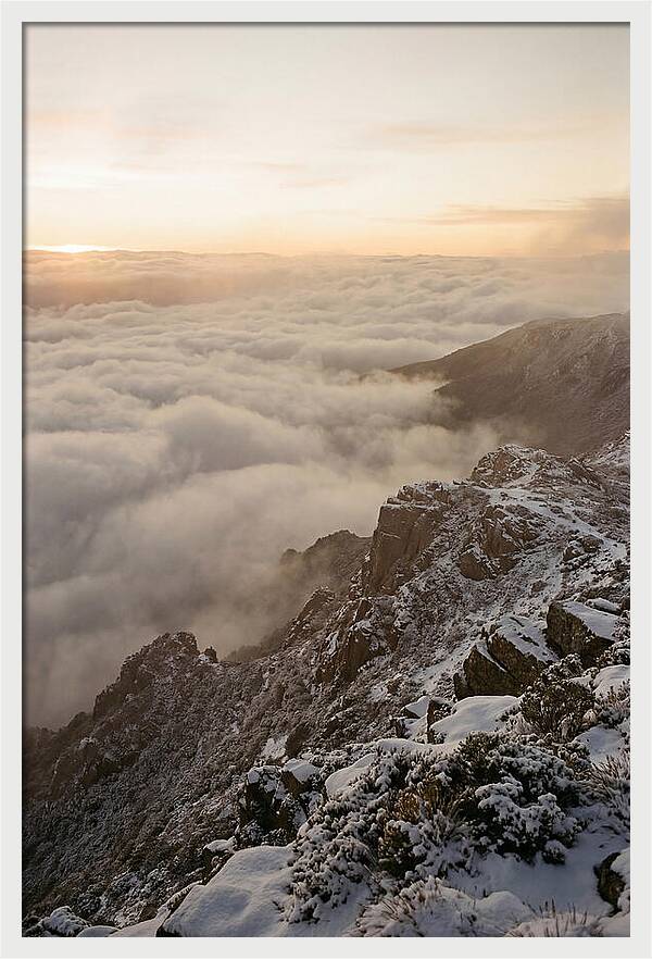 Snow Covered Ridge Line Above Sea Of Clouds