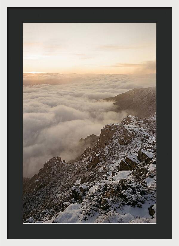 Snow Covered Ridge Line Above Sea Of Clouds