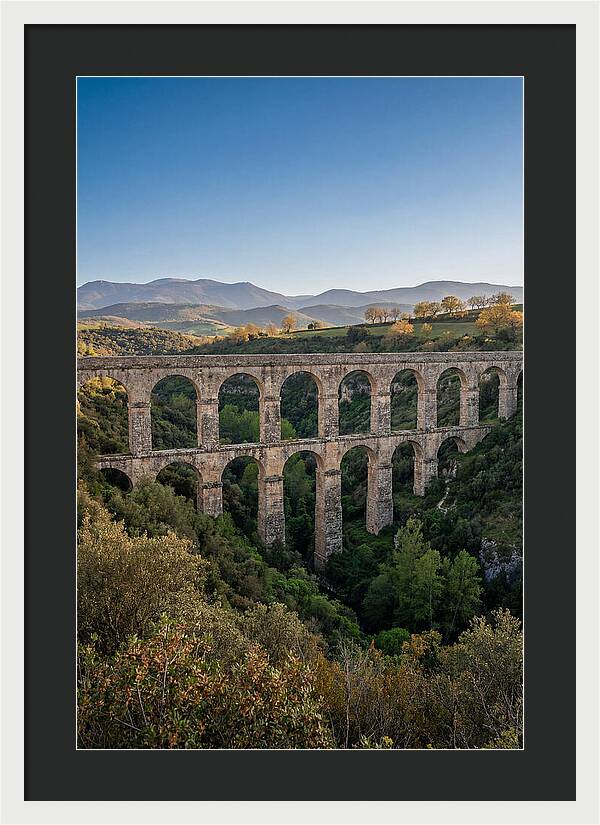 Stone Aqueduct Spanning Deep Green Valley
