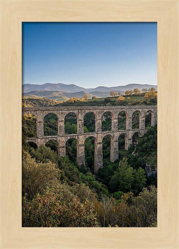 Stone Aqueduct Spanning Deep Green Valley