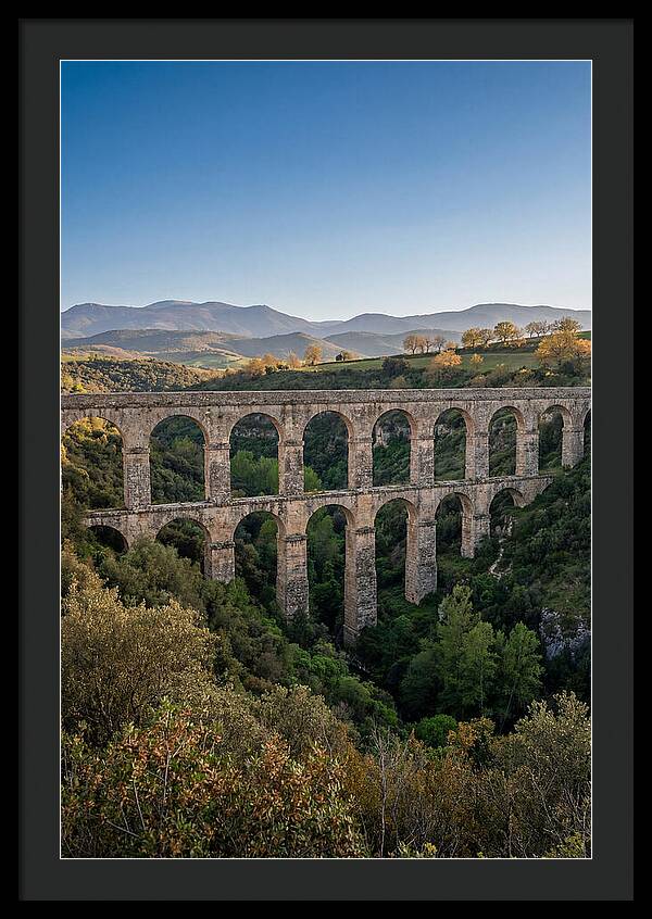 Stone Aqueduct Spanning Deep Green Valley