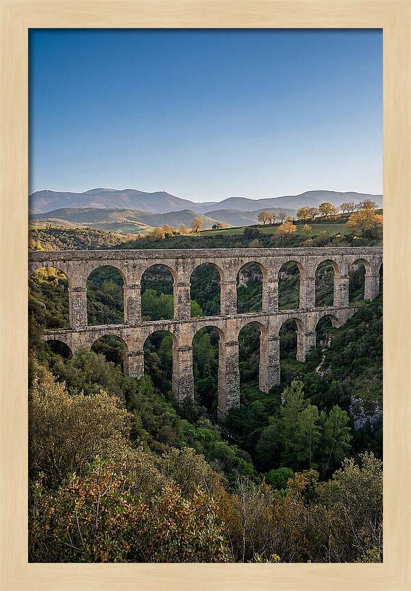 Stone Aqueduct Spanning Deep Green Valley