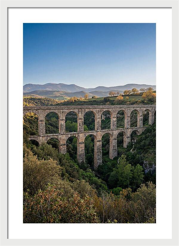 Stone Aqueduct Spanning Deep Green Valley