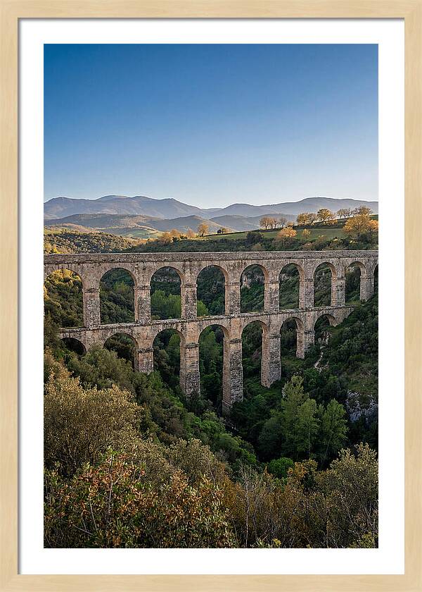 Stone Aqueduct Spanning Deep Green Valley