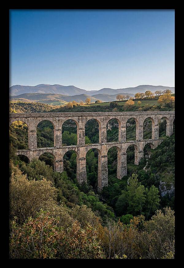 Stone Aqueduct Spanning Deep Green Valley