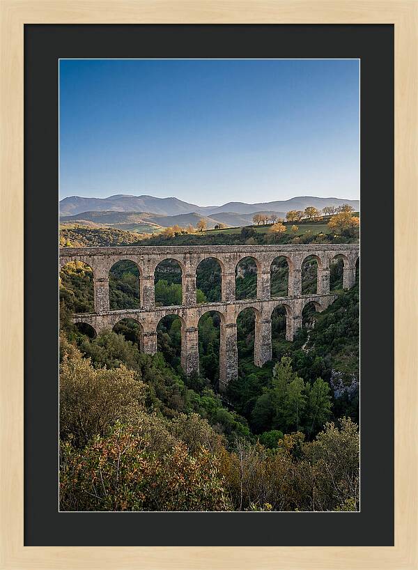 Stone Aqueduct Spanning Deep Green Valley