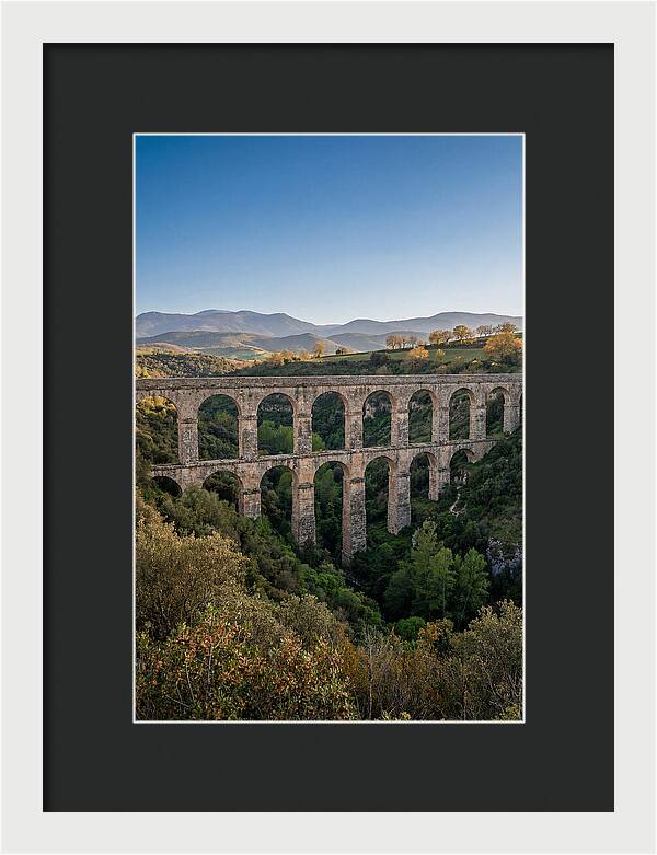 Stone Aqueduct Spanning Deep Green Valley