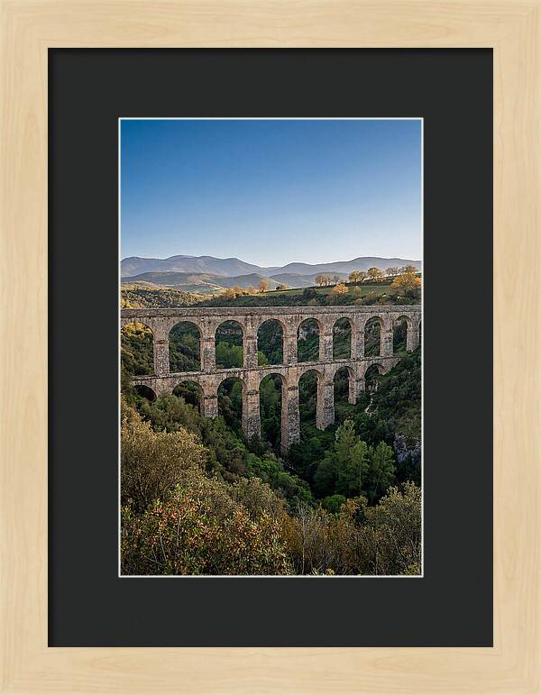 Stone Aqueduct Spanning Deep Green Valley