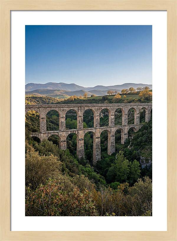 Stone Aqueduct Spanning Deep Green Valley