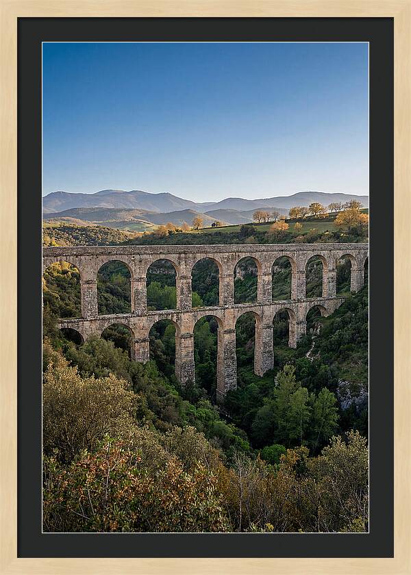 Stone Aqueduct Spanning Deep Green Valley