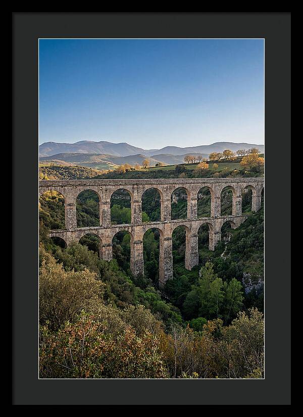 Stone Aqueduct Spanning Deep Green Valley