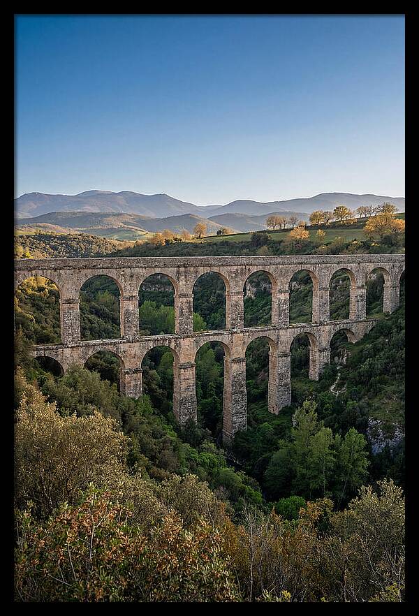 Stone Aqueduct Spanning Deep Green Valley