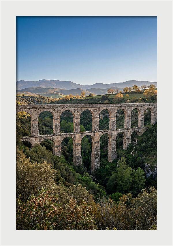 Stone Aqueduct Spanning Deep Green Valley