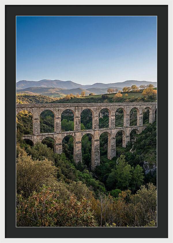Stone Aqueduct Spanning Deep Green Valley