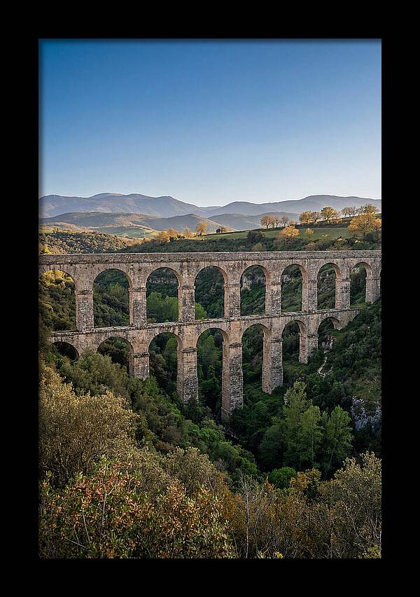 Stone Aqueduct Spanning Deep Green Valley