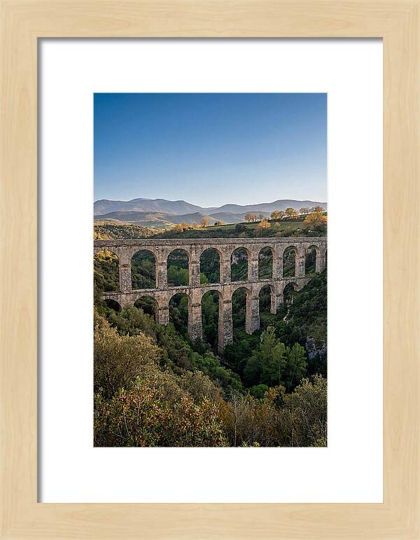 Stone Aqueduct Spanning Deep Green Valley