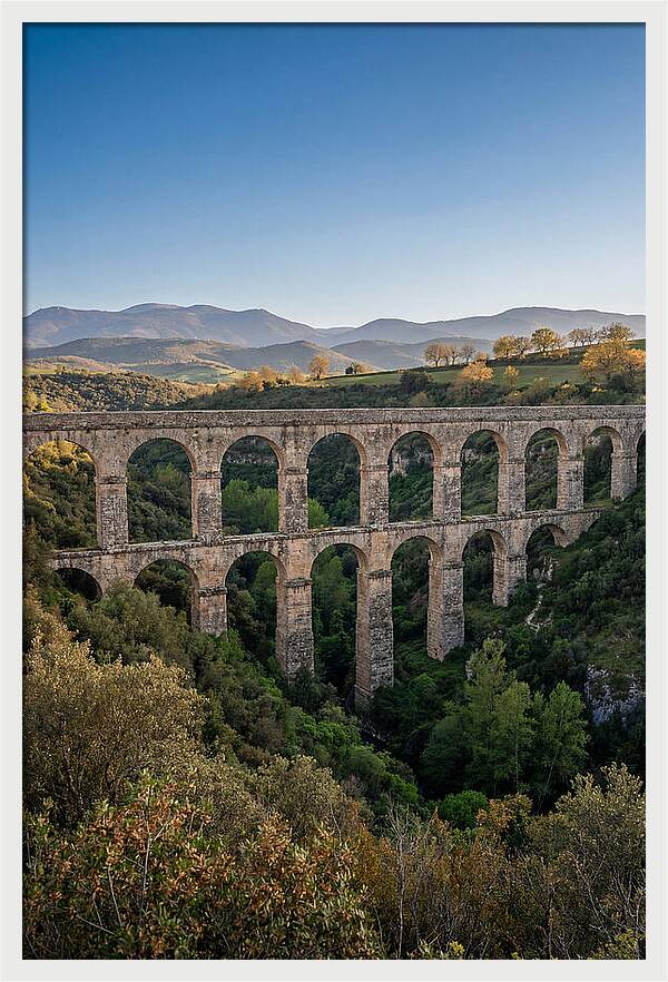 Stone Aqueduct Spanning Deep Green Valley