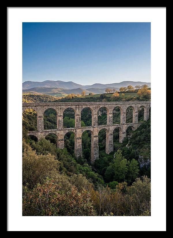 Stone Aqueduct Spanning Deep Green Valley