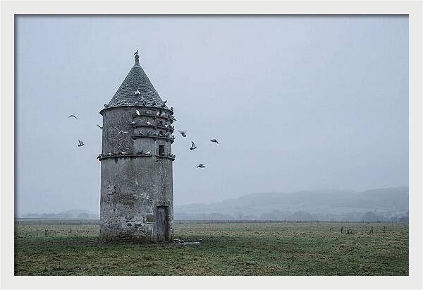 Stone Dovecote Tower In Misty Landscape