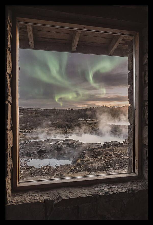 Vibrant Green Aurora Over Volcanic Landscape