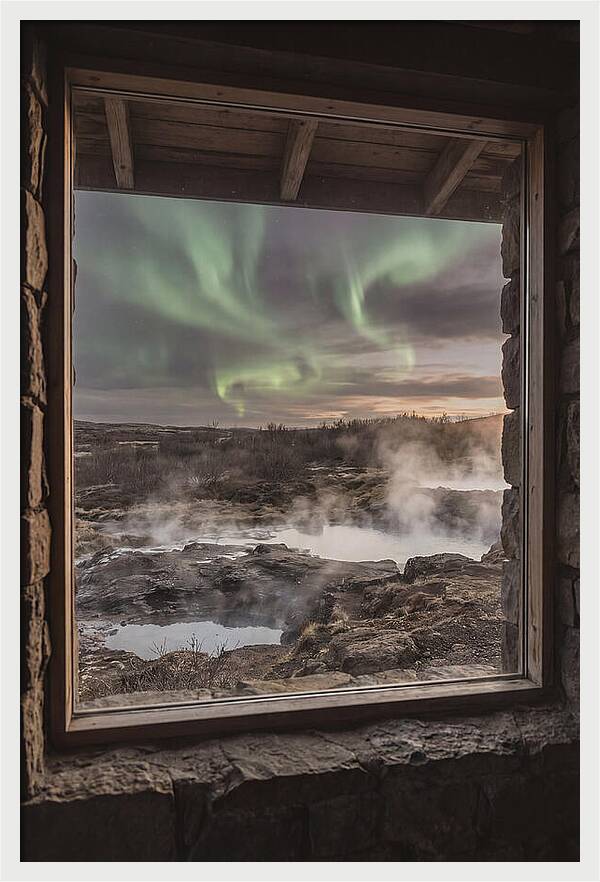 Vibrant Green Aurora Over Volcanic Landscape