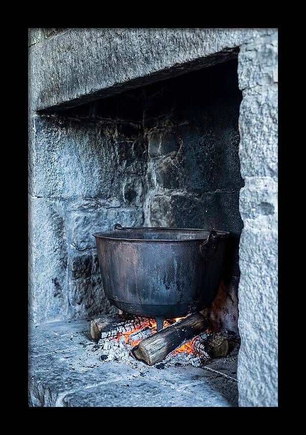 Vintage Iron Cauldron In Fireplace