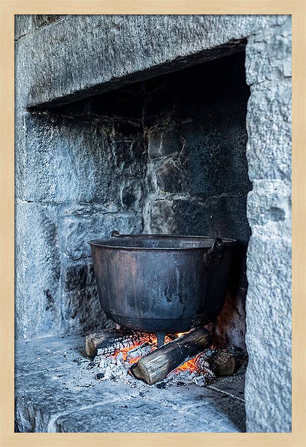 Vintage Iron Cauldron In Fireplace